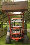 A cutie at the wheel of a tractor